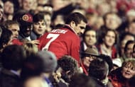 Eric Cantona of Manchester United is surrounded by the fans after an FA Carling Premiership match against Chelsea at Old Trafford in Manchester, England. The match ended in a 1-1 draw. Mandatory Credit: Ross Kinnaird/Allsport