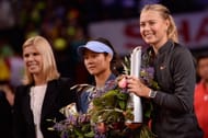 Maria Sharapova of Russia poses with her trophy after winning her final match against Na Li of China (C) during Day 7 of the Porsche Tennis Grand Prix at Porsche-Arena on April 28, 2013 in Stuttgart, Germany. (Photo by Dennis Grombkowski/Bongarts/Getty Images)