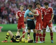 Bayern Munich's French midfielder Franck Ribery (3rd R) gestures after catching Borussia Dortmund's Polish striker Robert Lewandowski (L) in the face