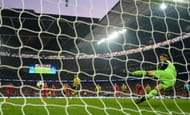 Ilkay Gundogan of Borussia Dortmund scores a goal from the penalty spot past Manuel Neuer of Bayern Munich