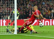 Neven Subotic of Borussia Dortmund (L) clears the ball off the line as Arjen Robben of Bayern Muenchen attempts a shot