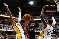 Dwyane Wade #3 of the Miami Heat goes up between Paul George #24 and Roy Hibbert #55 of the Indiana Pacers during Game Three of the Eastern Conference Finals at Bankers Life Fieldhouse on May 26, 2013 in Indianapolis, Indiana. (Photo by Gregory Shamus/Getty Images)