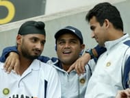 BRISBANE, AUSTRALIA: Indian cricketers Harbhajan Singh (L), Virender Sehwag (C) and Zaheer Khan (R), speak with each other as they watch the innings by their captain Sourav Ganguly, on day four of the first cricket Test, at the Gabba cricket ground in Brisbane, 07 December 2003. India finished the day on 6 for 362, with Ganguly out on 144. AFP PHOTO/Greg WOOD (Photo credit should read GREG WOOD/AFP/Getty Images)