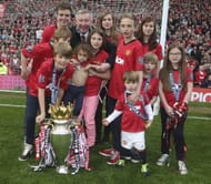 Grandad: Sir Alex Ferguson celebrates his 13th title with his eleven grandchildren . (Getty Images)