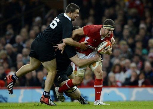 Sam Warburton (R) is tackled during their Autumn International rugby union match against N. Zealand on November 24, 2012