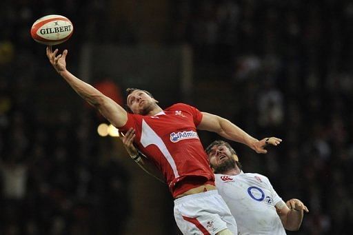 Wales flanker Sam Warburton reaches for the ball under pressure from England lock Geoff Parling on March 16, 2013