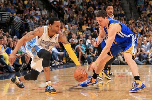 Andre Iguodala (L) and Klay Thompson vie for a loose ball on April 30, 2013