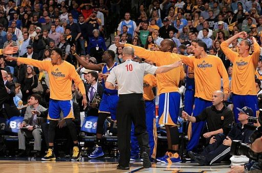 The Golden State Warriors signal in the opposite direction of referee Ron Garretson on April 30, 2013