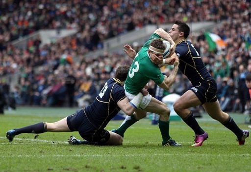 Ireland&#039;s Brian O&#039;Driscoll (C) is tackled by Scotland&#039;s centre Sean Lamont and wing Sean Maitland, February 24, 2013