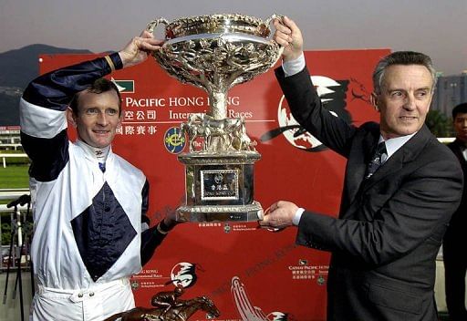 Irish jockey Kevin Manning (L) and trainer Jim Bolger display the Hong Kong Cup, December 12, 2004
