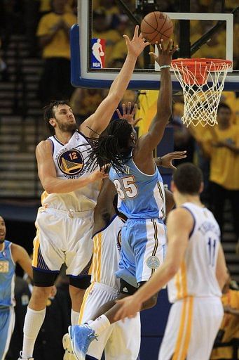 Golden State Warriors' Andrew Bogut tries to block a shot by Denver Nuggets' Kenneth Faried on May 2, 2013