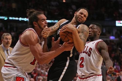 The Chicago Bulls' Joakim Noah (L) and Nate Robinson tries to stop the Brooklyn Nets' Deron Williams on May 2, 2013