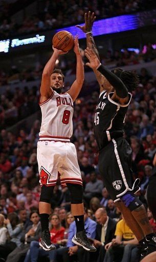 The Chicago Bulls' Marco Belinelli (L) shoots past Gerald Wallace of the Brooklyn Nets on May 2, 2013