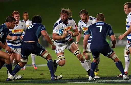 Western Stormers player Andries Bekker (centre) charges at the Auckland Blues defence in Auckland on May 3, 2013