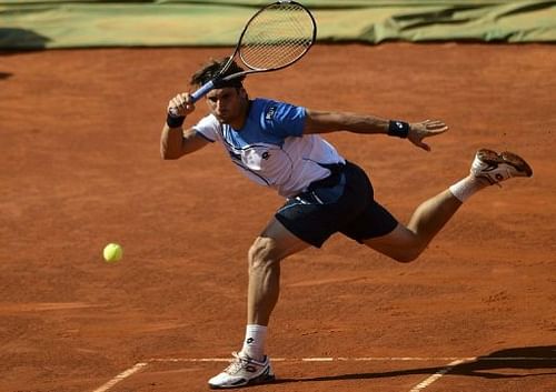 Spanish player David Ferrer returns the ball to Romanian player Victor Hanescu in Oeiras on May 3, 2013