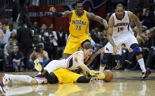 Kyle Korver of the Atlanta Hawks and Paul George of the Indiana Pacers fight for a loose ball, May 3, 2013 in Atlanta