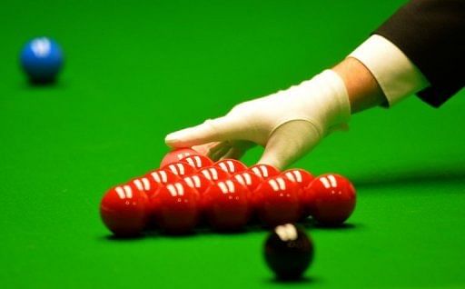 The referee places the pink ball at the World Snooker Championships at The Crucible in Sheffield, April 30, 2013