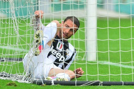 Juventus midfielder Claudio Marchisio untangles his foot from the goal net during a match against Torino, April 28, 2013