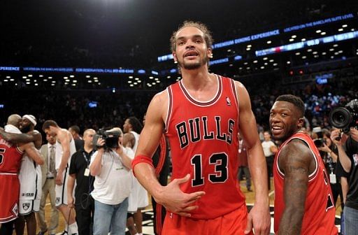 Joakim Noah (C) and Nate Robinson (R) of the Chicago Bulls celebrate their 99-93 win over the Brooklyn Nets, May 4, 2013