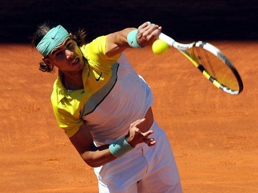 Rafael Nadal returns a ball against Roger Federer during their final match of the ATP Madrid Open on May 17, 2009