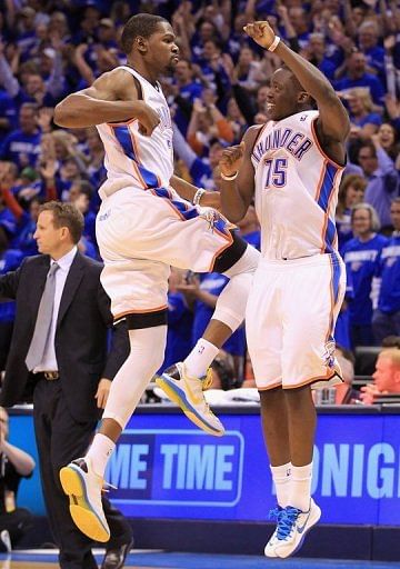 Kevin Durant (L) of the Oklahoma City Thunder celebrates with Reggie Jackson after making a shot on May 5, 2013