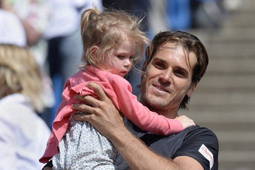 Tommy Haas holds his daughter after winning the BMW Open final against Philipp Kohlschreiber in Munich, on May 5, 2013