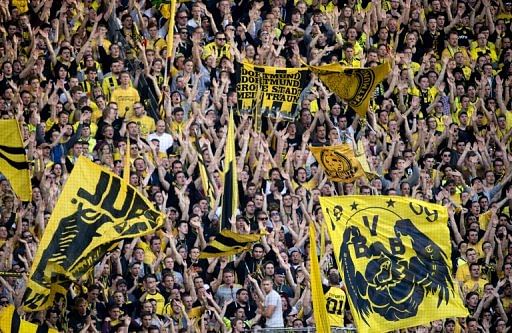 Borussia Dortmund fans cheer their side during a Bundesliga match against Bayern Munich in Dortmund, on May 4, 2013