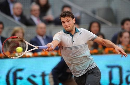 Grigor Dimitrov returns the ball to Novak Djokovic in Madrid on May 7, 2013