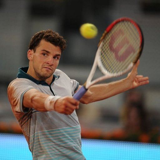 Grigor Dimitrov returns the ball to Novak Djokovic in Madrid on May 7, 2013
