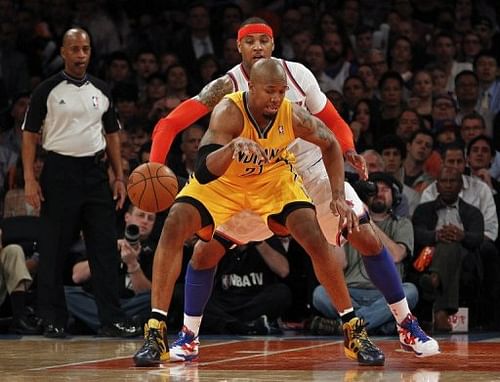 New York Knicks' Carmelo Anthony knocks the ball away from David West of the Indiana Pacers, May 7, 2013 in New York