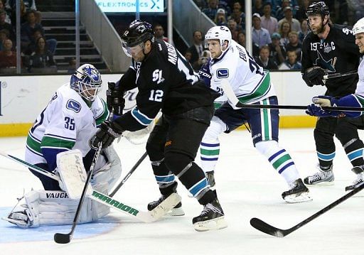 Patrick Marleau (C) of the San Jose Sharks scores the game winning goal against the Vancouver Canucks, May 7, 2013