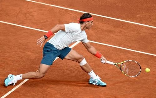 Rafael Nadal returns the ball to Benoit Paire in their first round match at the Madrid Masters on May 8, 2013