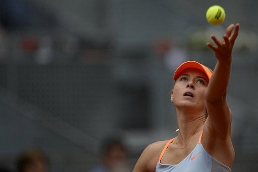 Maria Sharapova serves against German player Sabine Lisicki during their women&#039;s singles match in Madrid on May 9, 2013