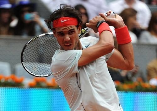 Rafael Nadal returns the ball to Benoit Paire during their match at the Madrid Masters in Madrid on May 8, 2013