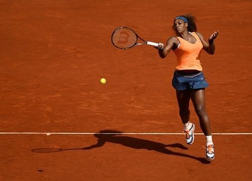 Serena Williams returns the ball to Anabel Medina during their match at the Madrid Masters in Madrid on May 10, 2013