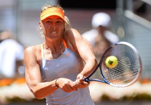 Maria Sharapova returns a ball to Kaia Kanepi during their match at the Madrid Masters in Madrid on May 10, 2013