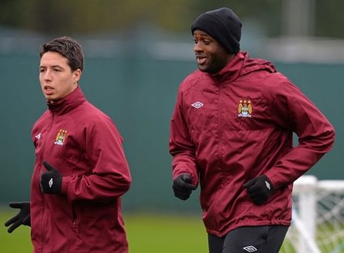 Manchester City's Samir Nasri (L) and Yaya Toure warm up during a training session, on May 10, 2013 Manchester City's Samir Nasri (L) and Yaya Toure warm up during a training session, on May 10, 2013