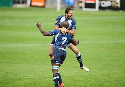 Castres&#039;s Captain Remy Tales (Top) celebrates with Ibrahim Diarra on May 11, 2013 in Castres