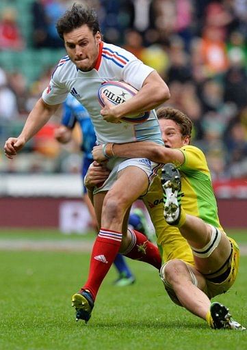 France&#039;s Thibaut Zambelli (L) is tackled by Australia&#039;s James Stannard