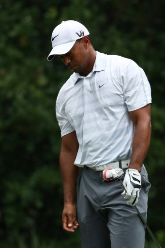 Tiger Woods reacts after playing a shot from the 11th tee during round three of The Players May 11, 2013 in Florida