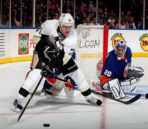 Evgeni Malkin of the Pittsburgh Penguins looks to pass as Evgeni Nabokov of the New York Islanders defends, May 11, 2013