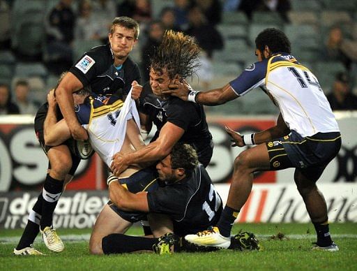 Southern Kings players tackle ACT Brumbies player Pat McCabe during the Super 15 match in Canberra, April 5, 2013