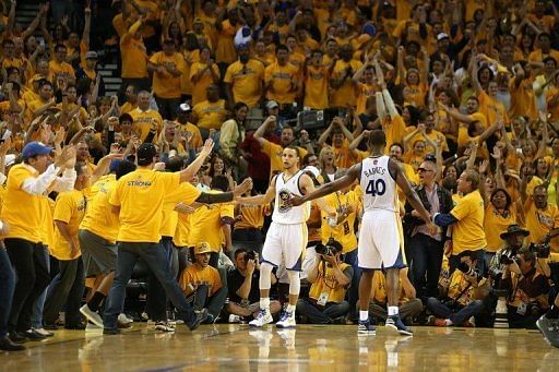 Stephen Curry (C) and Harrison Barnes of the Golden State Warriors celebrate on May 12, 2013