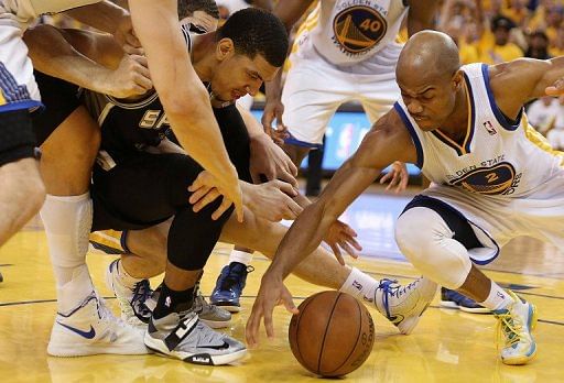 Jarrett Jack (R) of the Warriors battles for the ball with Danny Green of the Spurs, in Oakland, on May 12, 2013