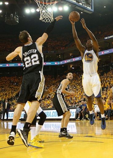 Harrison Barnes (R) of the Golden State Warriors shoots against the San Antonio Spurs, in Oakland, on May 12, 2013
