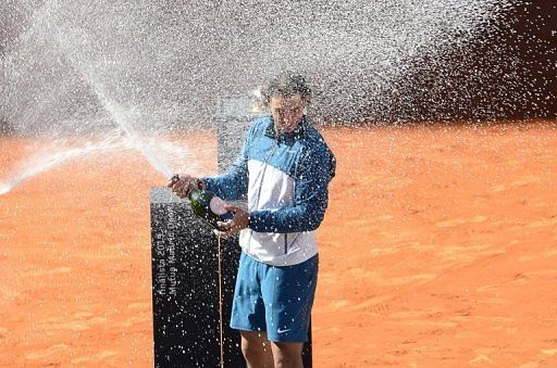 Rafael Nadal celebrates after winning the Madrid Masters tournament on May 12, 2013