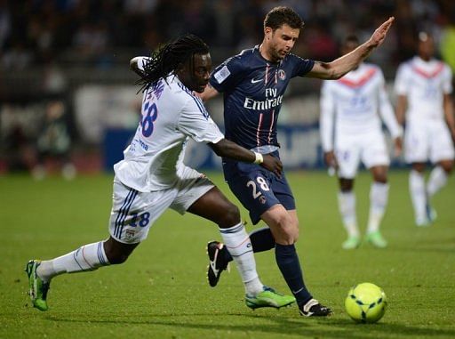 Paris Saint-Germain&#039;s Thiago Motta (R) and Lyon&#039;s Bafetimbi Gomis are pictured during their match on May 12, 2013