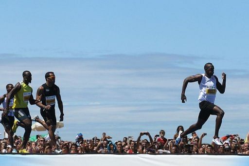 Jamaican runner Usain Bolt (right) competes in Copacabana Beach in Rio de Janeiro, Brazil, on March 31, 2013