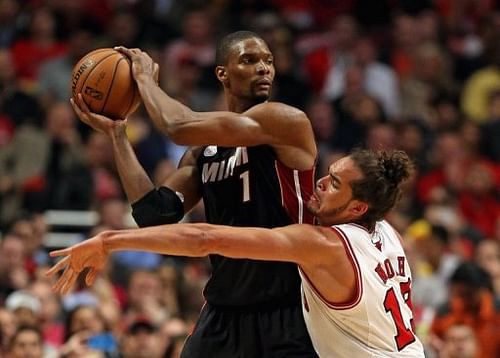 Chris Bosh of the Miami Heat tries to pass past Chicago Bulls' Joakim Noah at the United Center on May 13, 2013