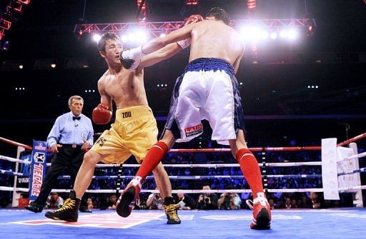 China&#039;s Zou Shiming (C) competes against Eleazar Valenzuela during their flyweight bout in Macau on April 6, 2013